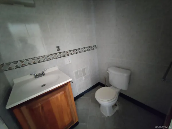 a white toilet sitting next to a bathroom sink
