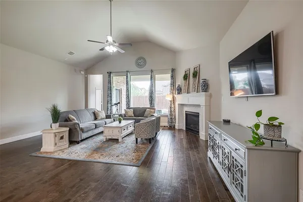 a living room with fireplace furniture and a flat screen tv