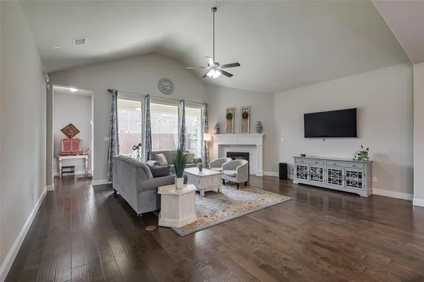a living room with furniture fireplace and a flat screen tv