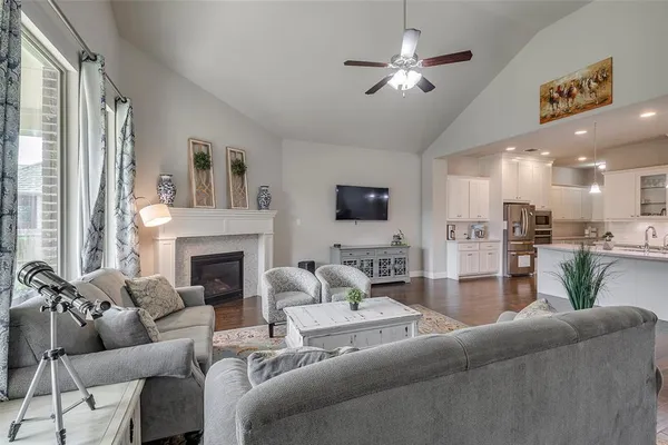 a living room with furniture fireplace and a flat screen tv