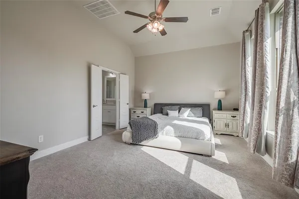 a living room with furniture a ceiling fan and a rug