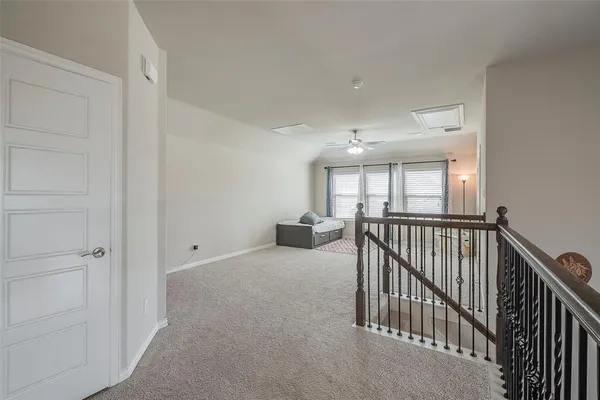 a view of a hallway with windows and stairs