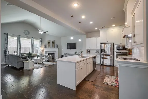 a large white kitchen with lots of counter top space