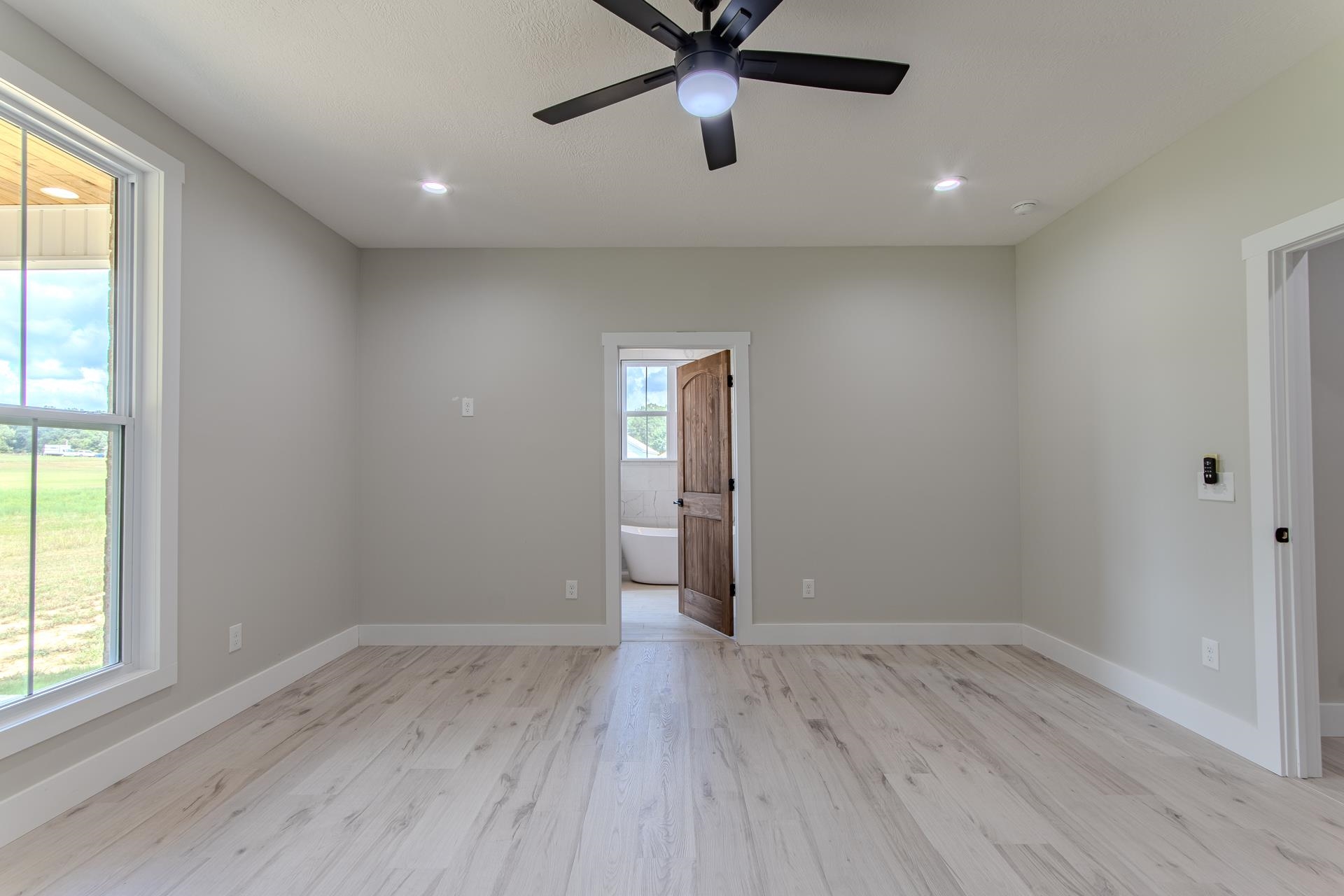 90 Columbus Lane Adamsville, TN 38310 - Photo 13 of 40 wooden floor in an empty room with a window