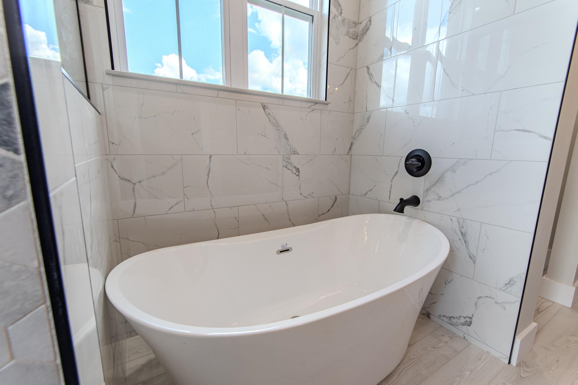 90 Columbus Lane Adamsville, TN 38310 - Photo 15 of 40 a white bath tub sitting in a bathroom