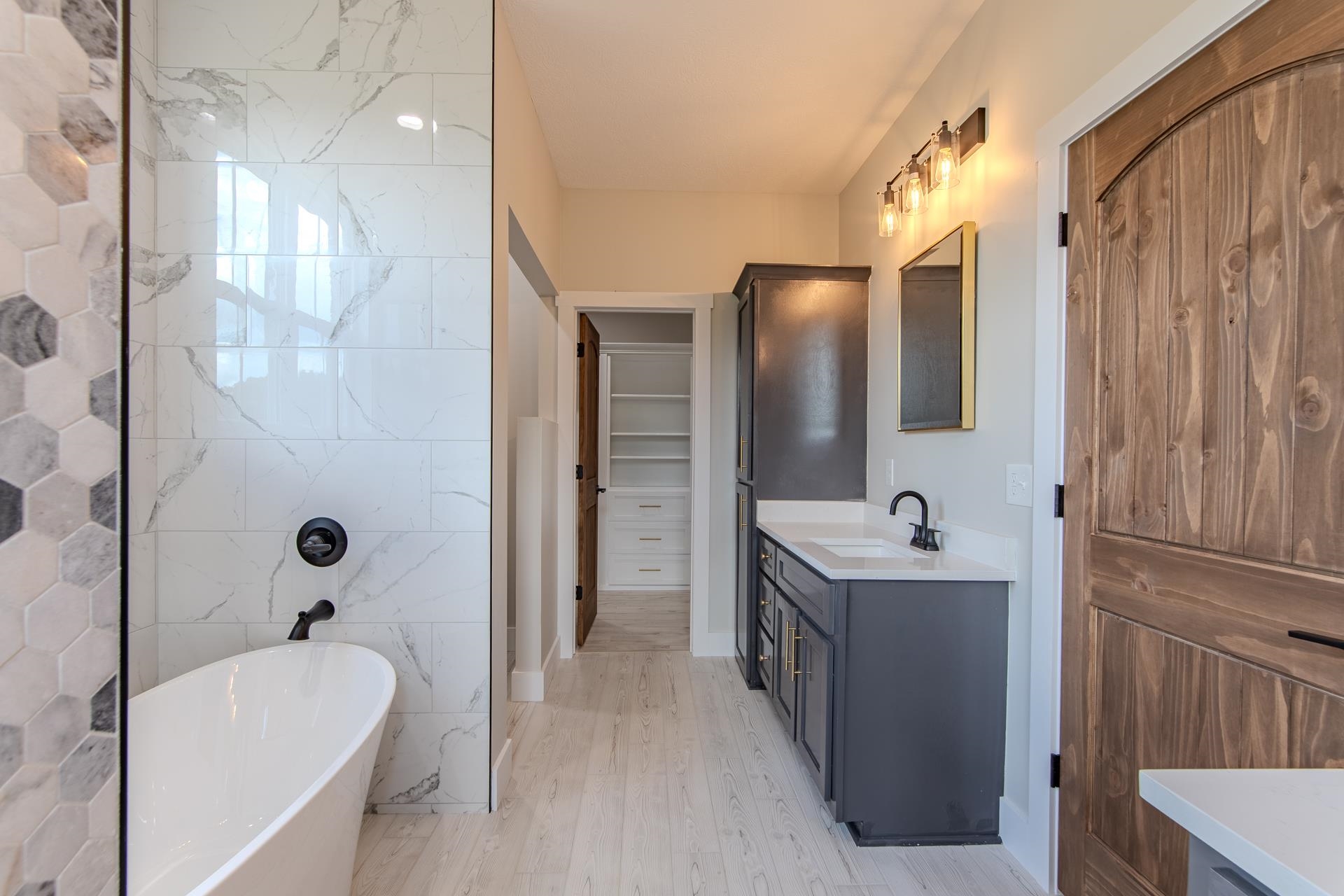 90 Columbus Lane Adamsville, TN 38310 - Photo 17 of 40 a bathroom with a tub sink shower and mirror