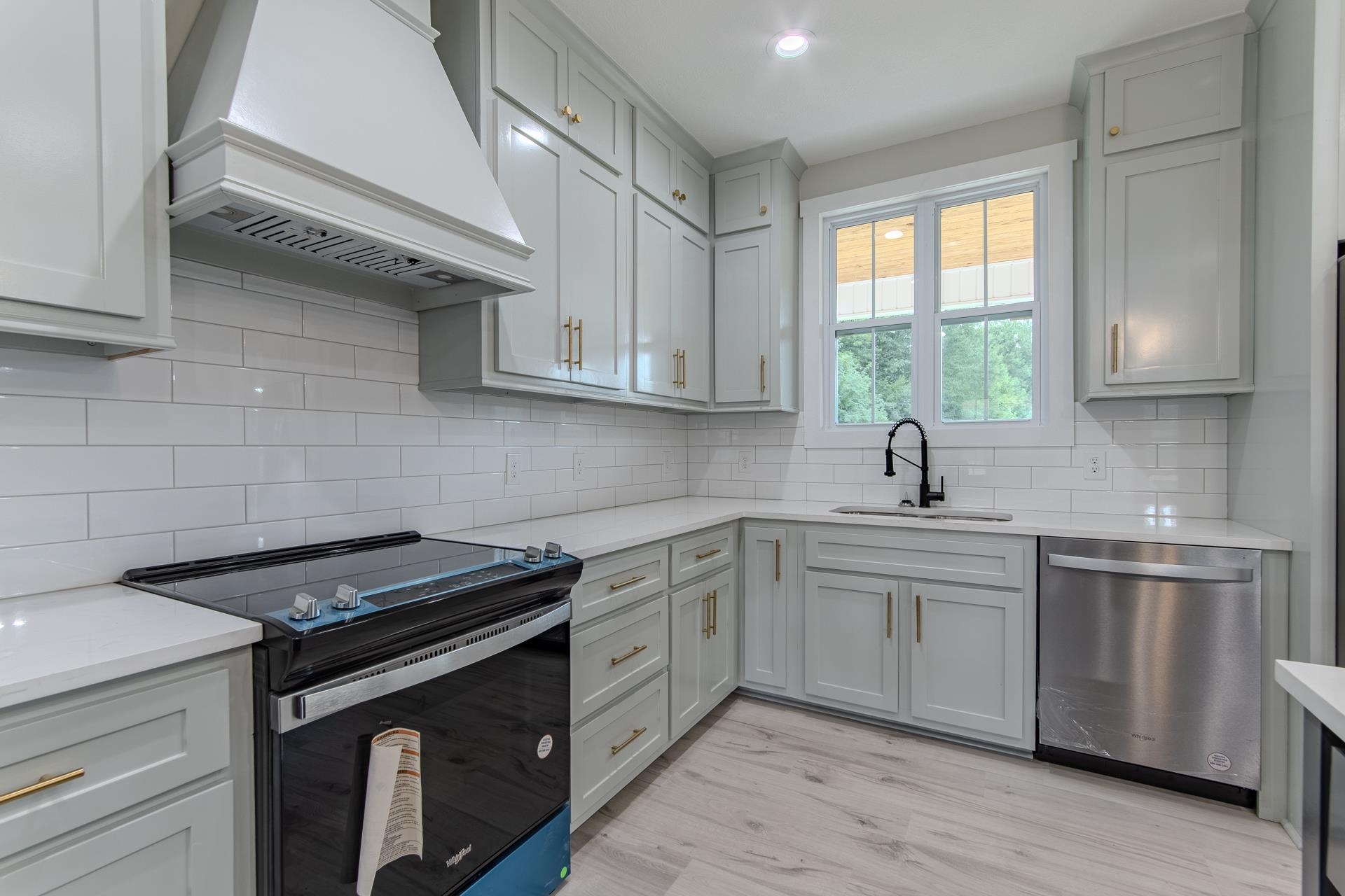 90 Columbus Lane Adamsville, TN 38310 - Photo 2 of 40 a kitchen with stainless steel appliances granite countertop a sink a stove a microwave and cabinets