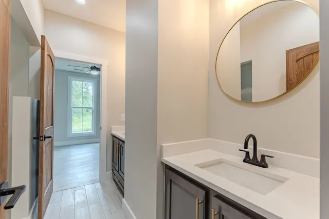 a bathroom with a sink a vanity and a mirror