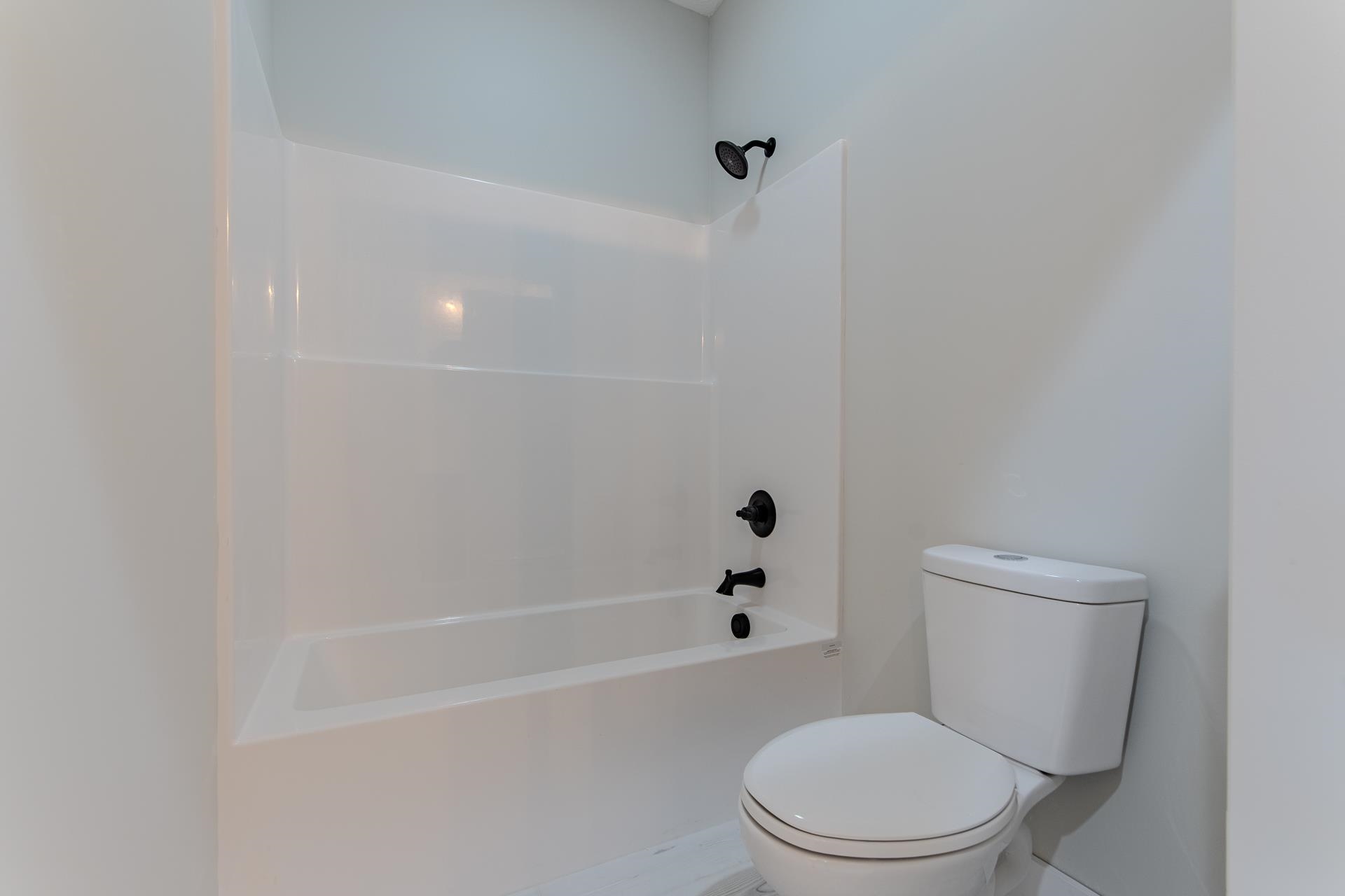 90 Columbus Lane Adamsville, TN 38310 - Photo 25 of 40 a white toilet and tub sitting next to a bathroom sink