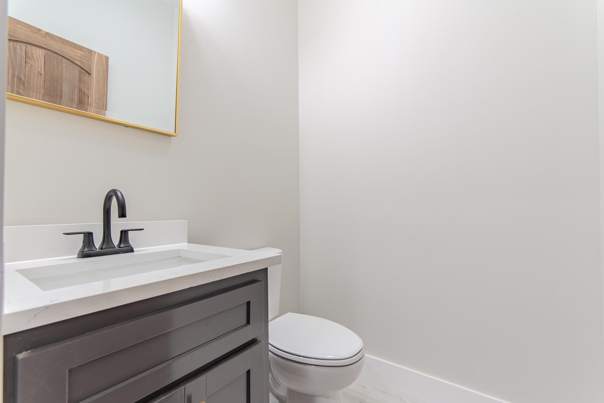 90 Columbus Lane Adamsville, TN 38310 - Photo 29 of 40 a bathroom with a toilet a sink and mirror