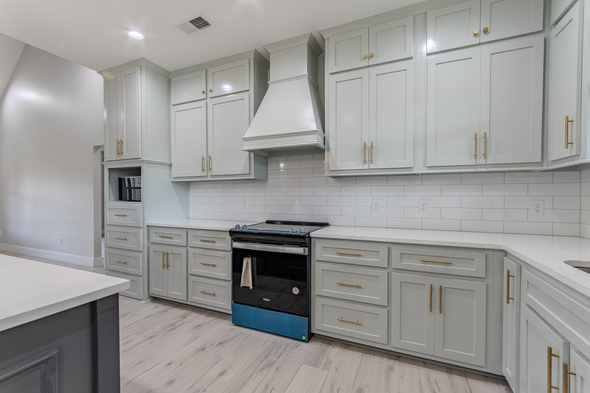90 Columbus Lane Adamsville, TN 38310 - Photo 3 of 40 a kitchen with white cabinets and white appliances