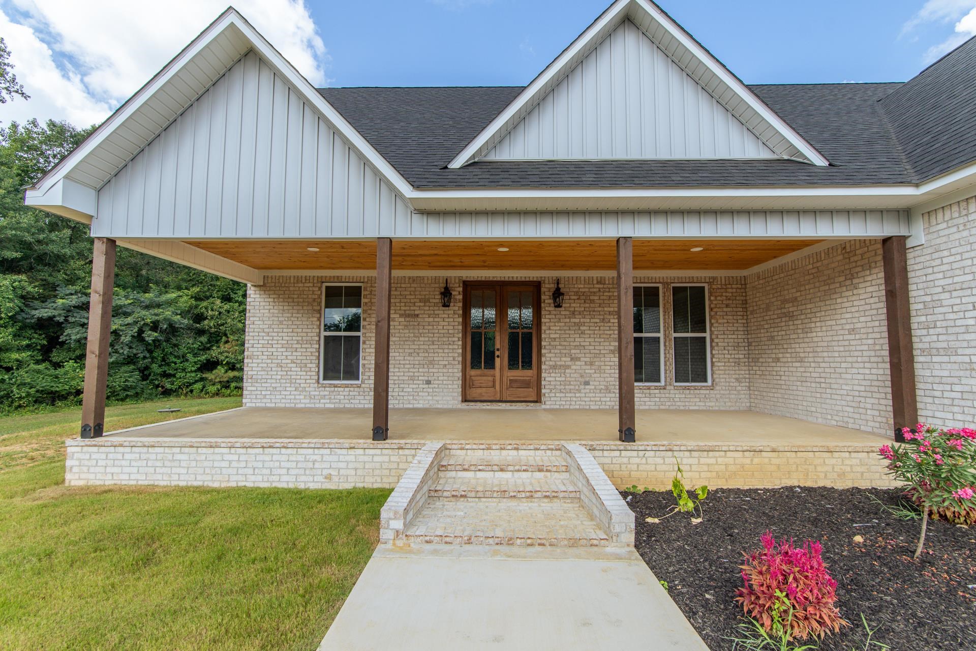90 Columbus Lane Adamsville, TN 38310 - Photo 33 of 40 a front view of a house with a porch