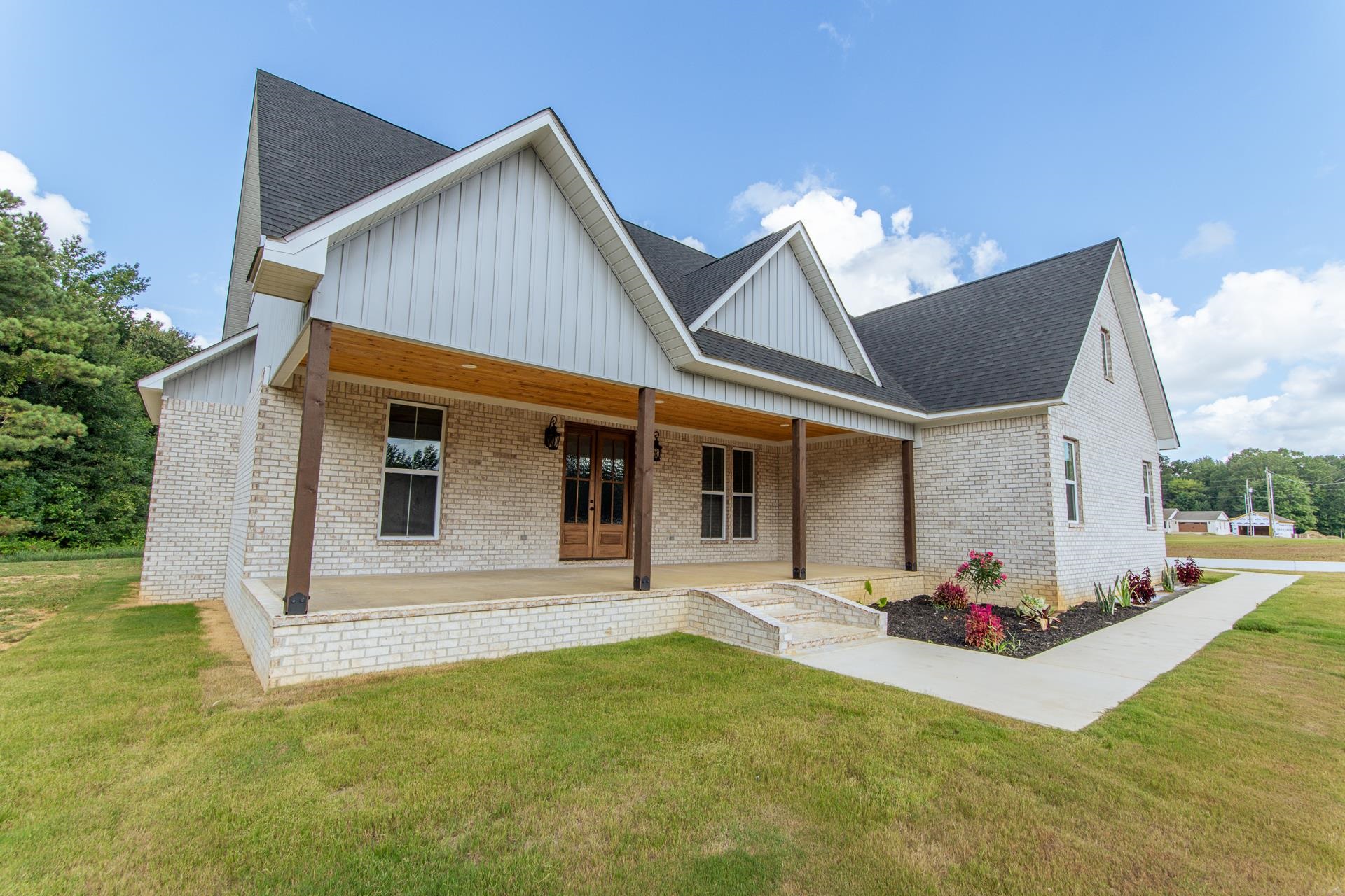 90 Columbus Lane Adamsville, TN 38310 - Photo 34 of 40 a view of a house with backyard and sitting area
