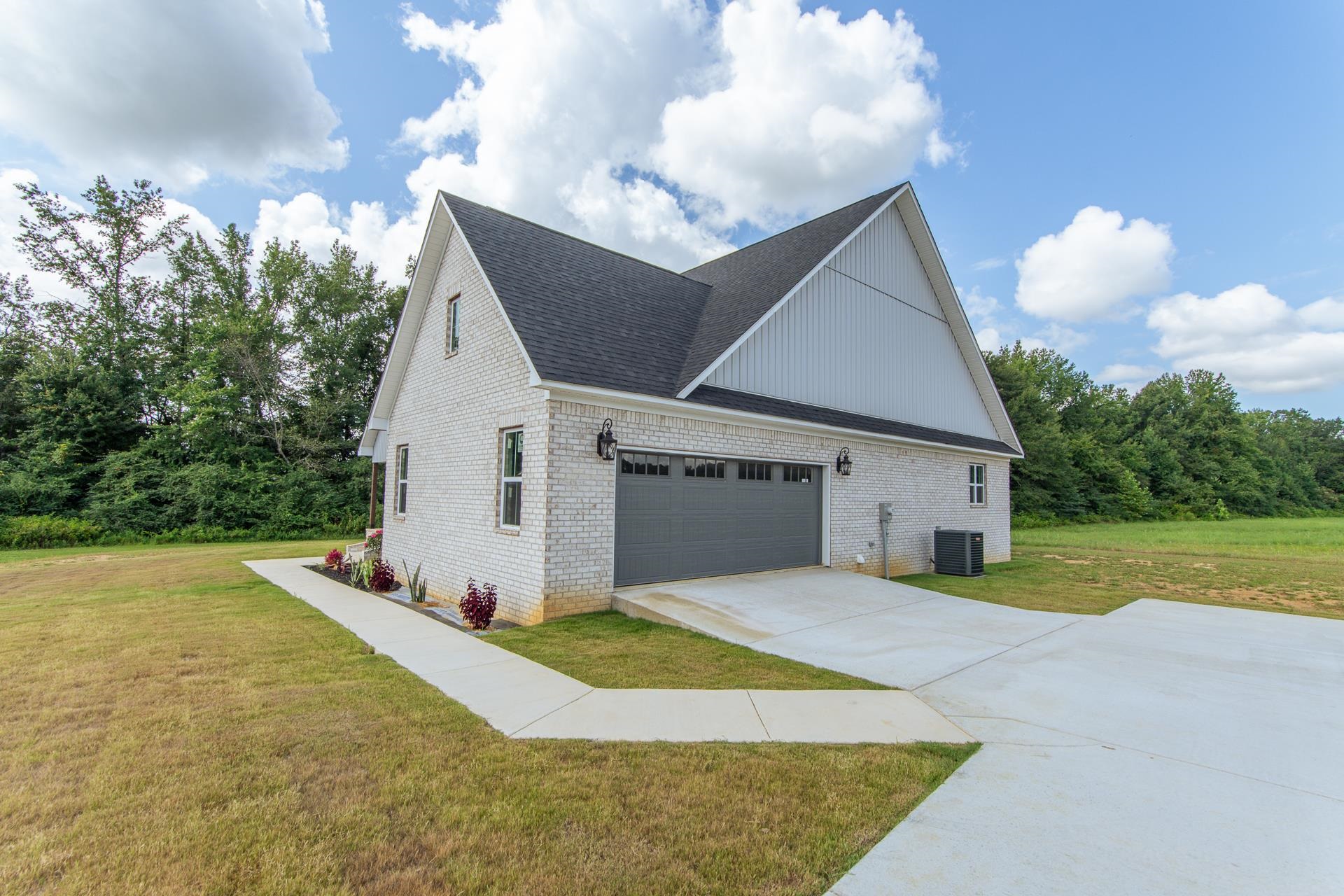 90 Columbus Lane Adamsville, TN 38310 - Photo 36 of 40 a view of a house with backyard and garden