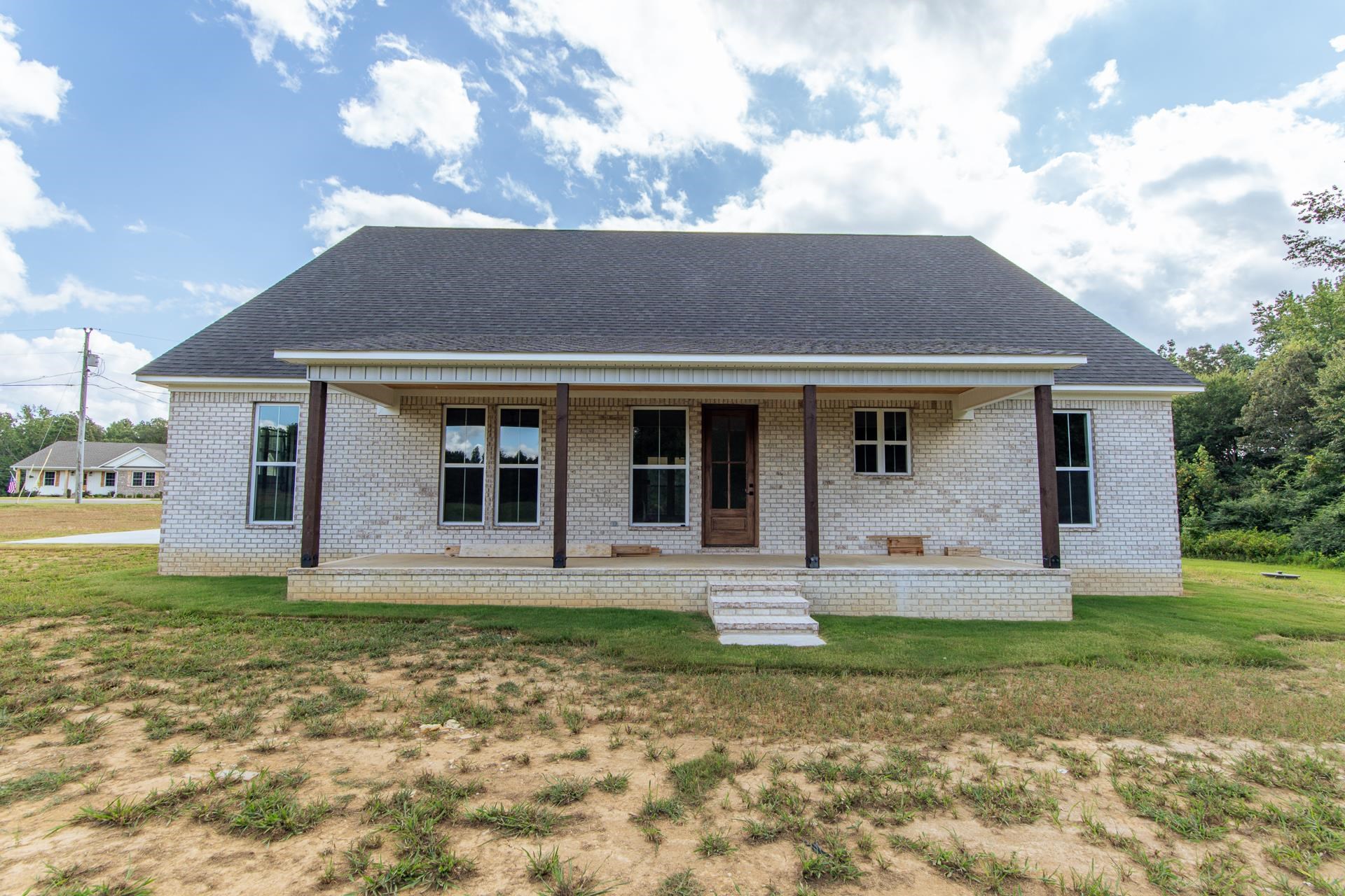 90 Columbus Lane Adamsville, TN 38310 - Photo 37 of 40 a front view of a house with garden