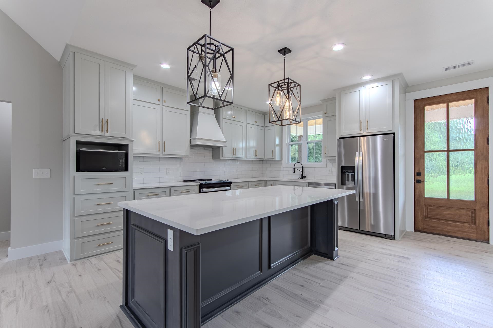 90 Columbus Lane Adamsville, TN 38310 - Photo 4 of 40 a kitchen with stainless steel appliances granite countertop a sink a refrigerator and a stove
