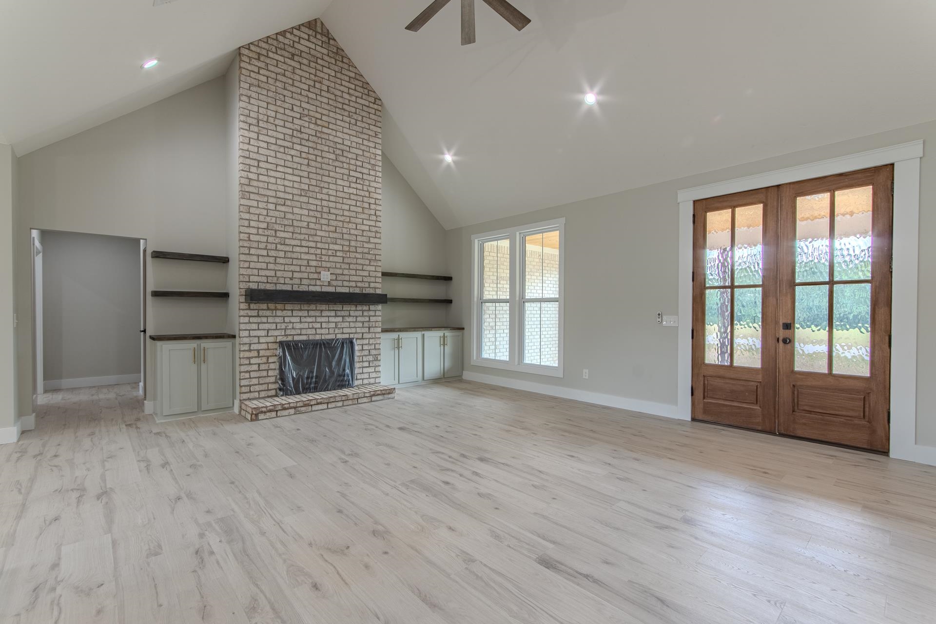 90 Columbus Lane Adamsville, TN 38310 - Photo 7 of 40 an empty room with windows and fireplace