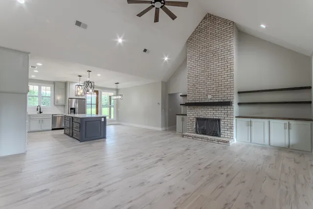 an open kitchen with a table and kitchen view