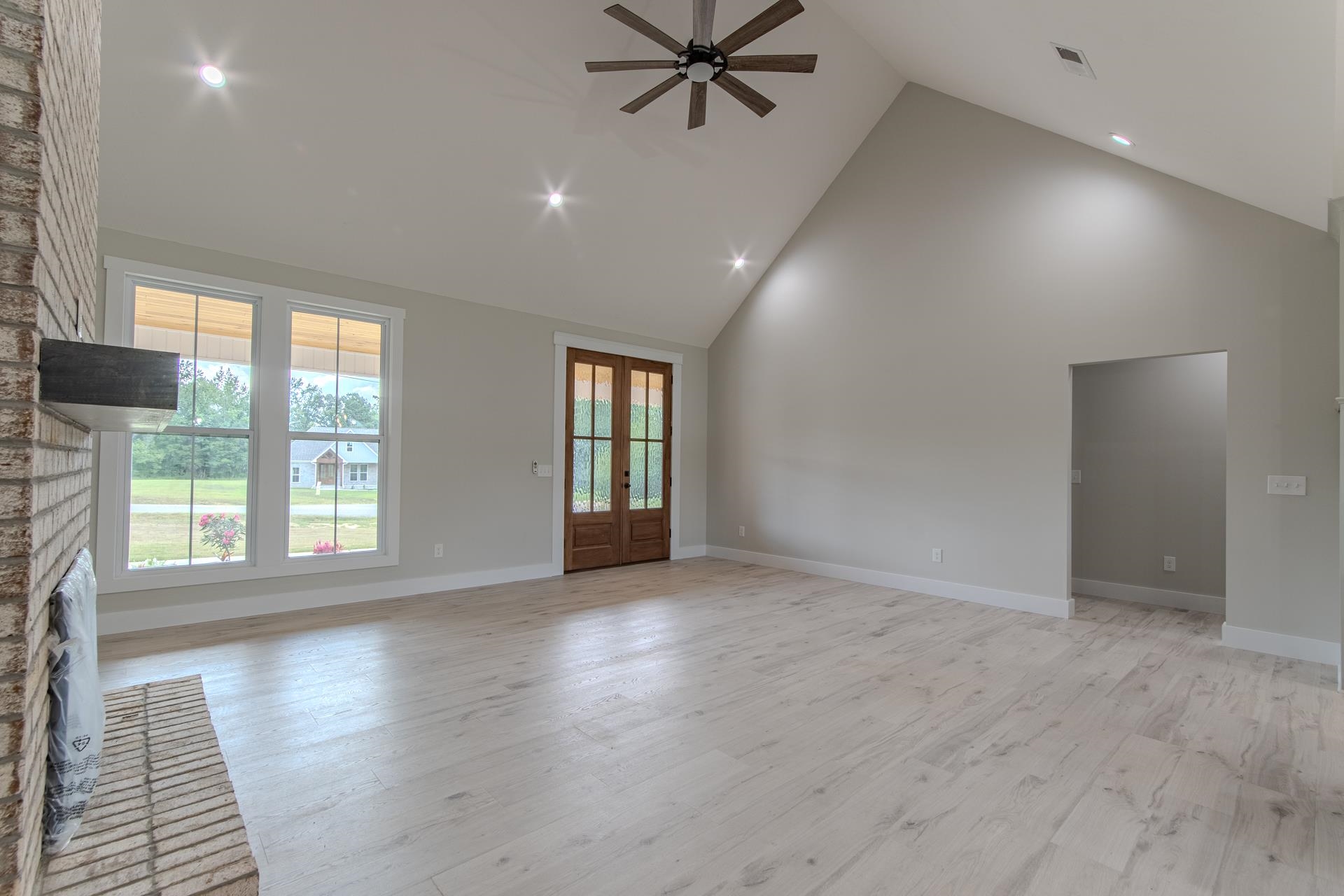 90 Columbus Lane Adamsville, TN 38310 - Photo 10 of 40 a view of an empty room with a window and wooden floor