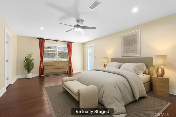 a spacious bedroom with a bed and a chandelier
