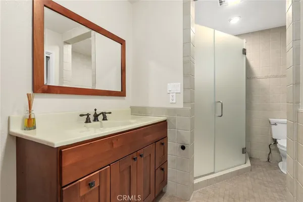 a bathroom with a sink vanity toilet and shower