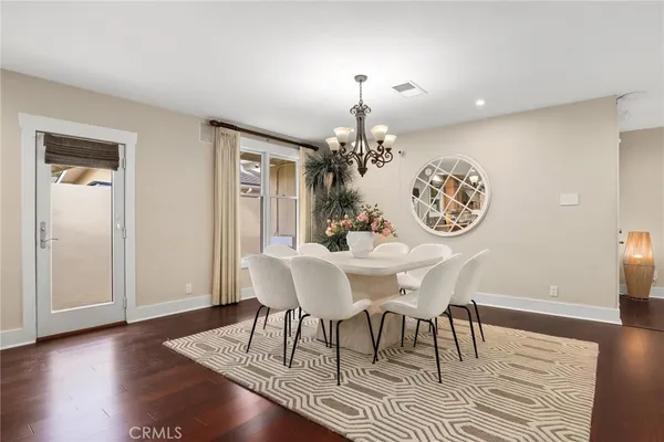 a view of a dining room with furniture wooden floor and chandelier
