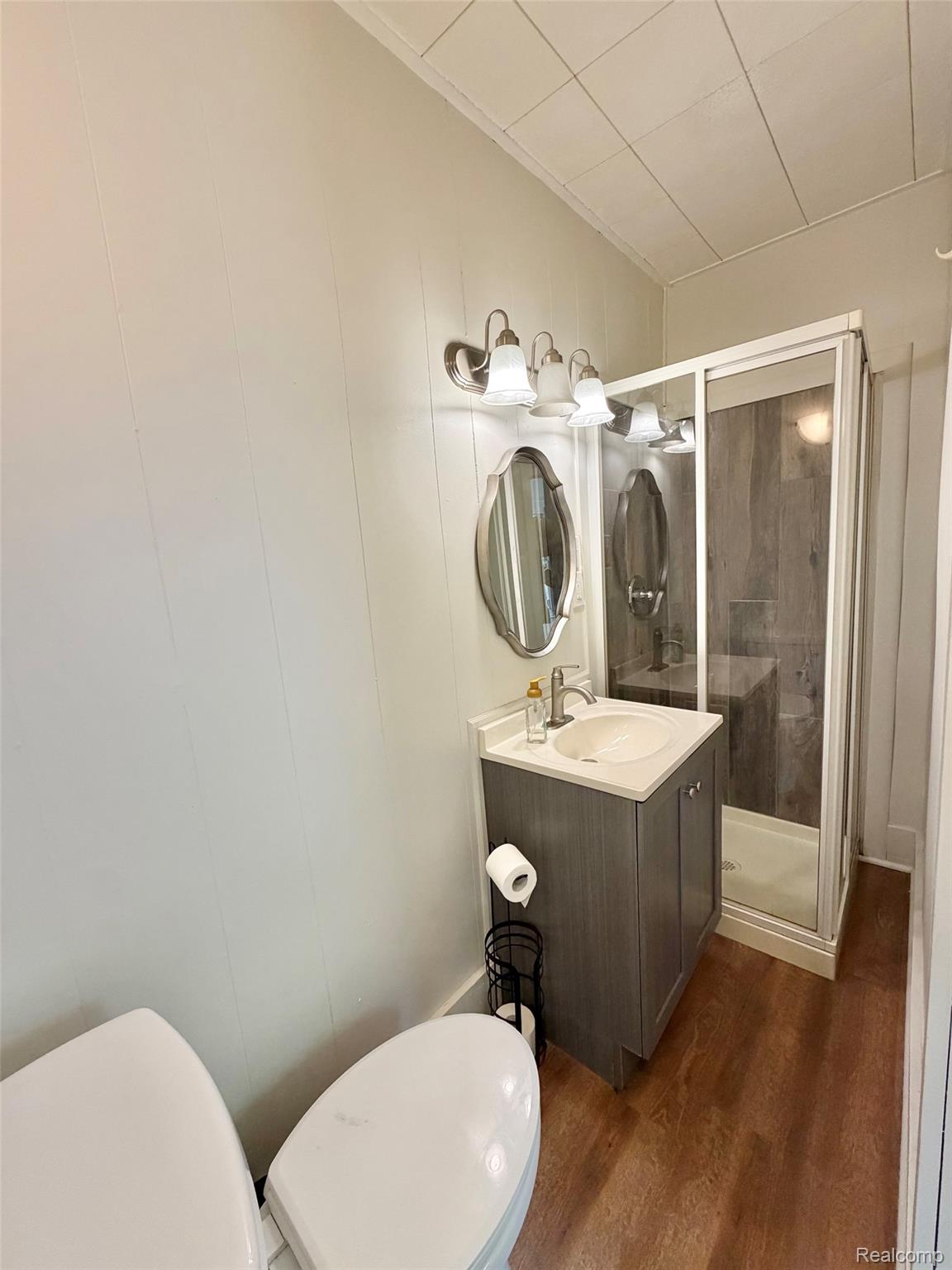 2840 Miller Road Flint, MI 48503 - Photo 20 of 49 Wood-finish flooring with a vanity featuring a white countertop and integrated sink
