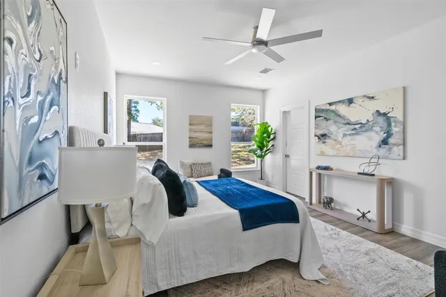 a living room with furniture and kitchen view with wooden floor