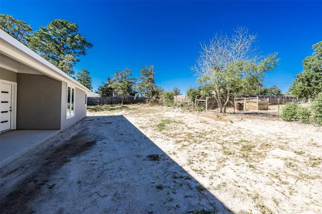 a view of a backyard of the house