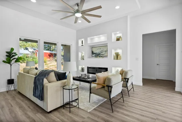 a kitchen with a granite countertop sink cabinets and wooden floor