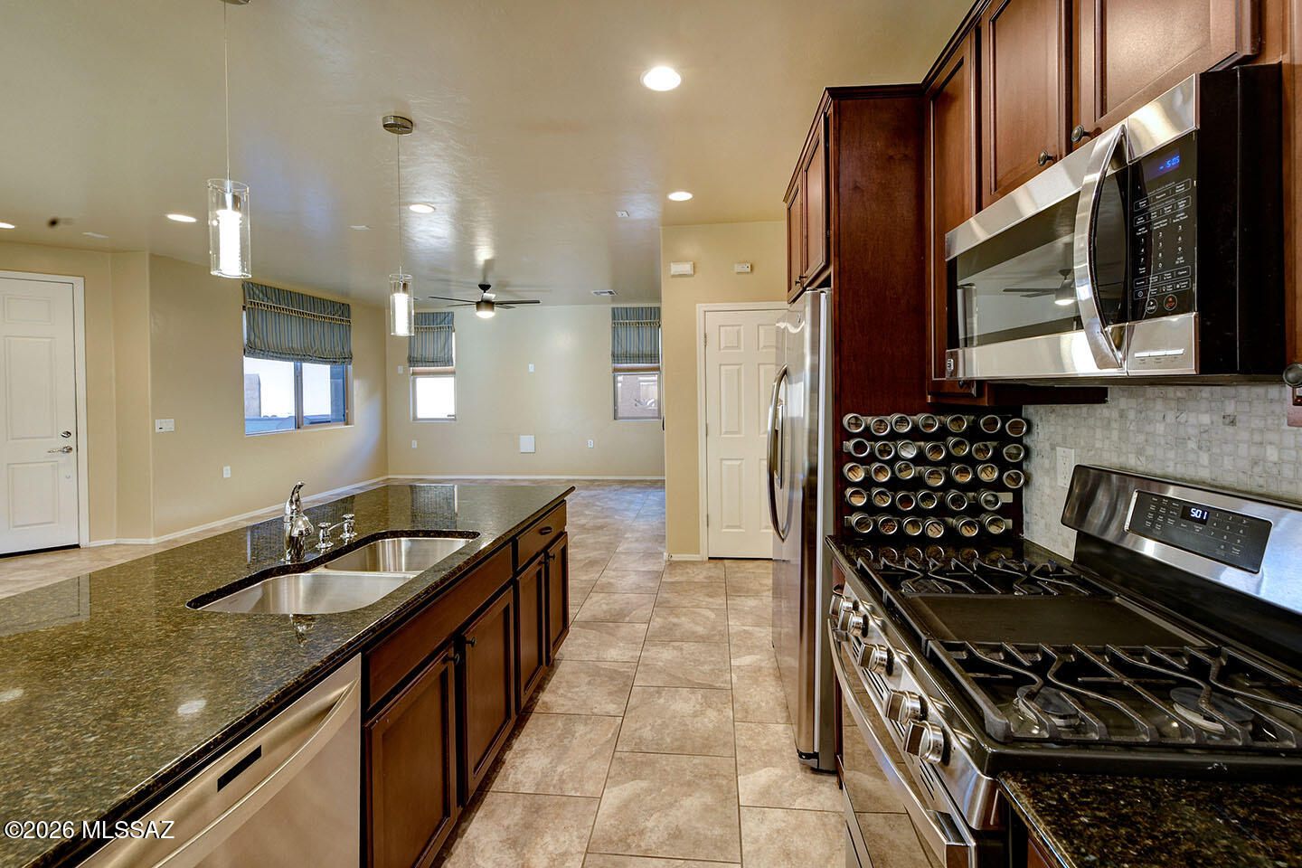 13991 East Cheavront Loop Vail, AZ 85641 - Photo 8 of 47 a kitchen with a sink stove and cabinets