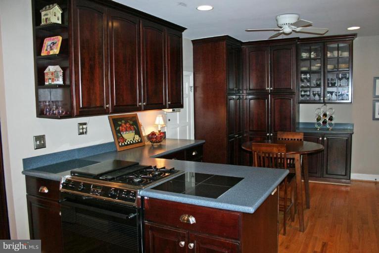 201 Goodale Road Baltimore, MD 21212 - Photo 13 of 30 a kitchen with granite countertop a stove and wooden cabinets