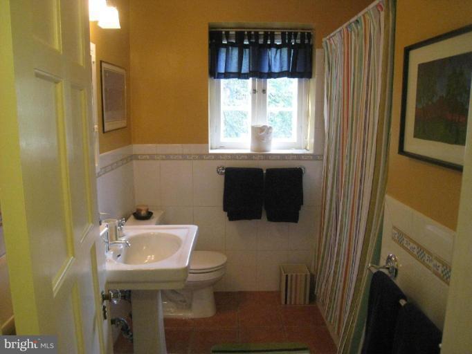 201 Goodale Road Baltimore, MD 21212 - Photo 3 of 30 a bathroom with a sink toilet and mirror