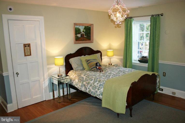 201 Goodale Road Baltimore, MD 21212 - Photo 26 of 30 a bedroom with a bed and a chandelier