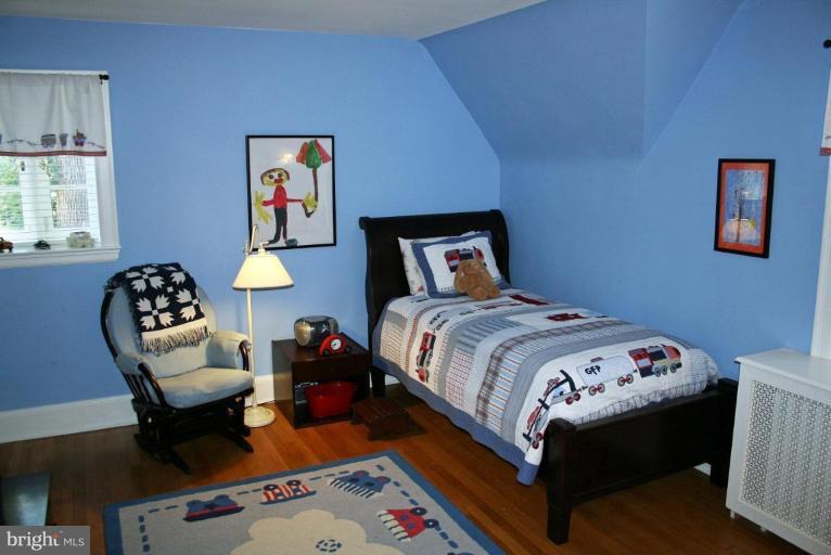 201 Goodale Road Baltimore, MD 21212 - Photo 27 of 30 a bedroom with a bed a dresser and chair