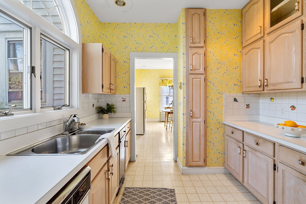 118 Sanders Avenue Lowell, MA 01851 - Photo 13 of 42 a kitchen with a sink stove and cabinets
