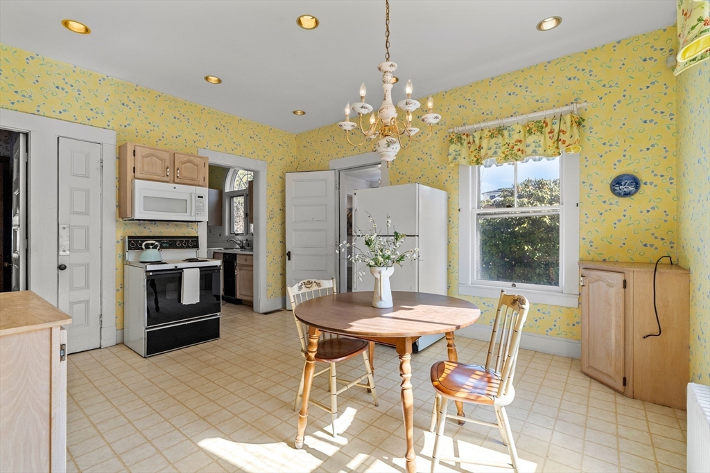 118 Sanders Avenue Lowell, MA 01851 - Photo 16 of 42 a view of a dining room with furniture and a chandelier