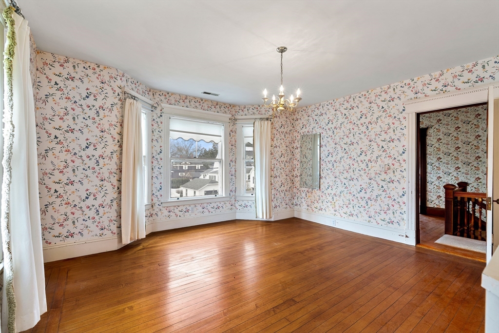 118 Sanders Avenue Lowell, MA 01851 - Photo 25 of 42 a view of an empty room with wooden floor and a window