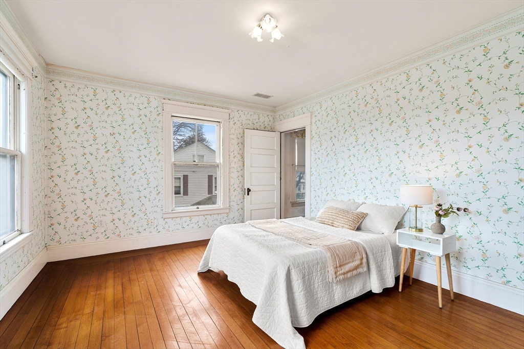 118 Sanders Avenue Lowell, MA 01851 - Photo 31 of 42 a bedroom with a bed and a wooden floor