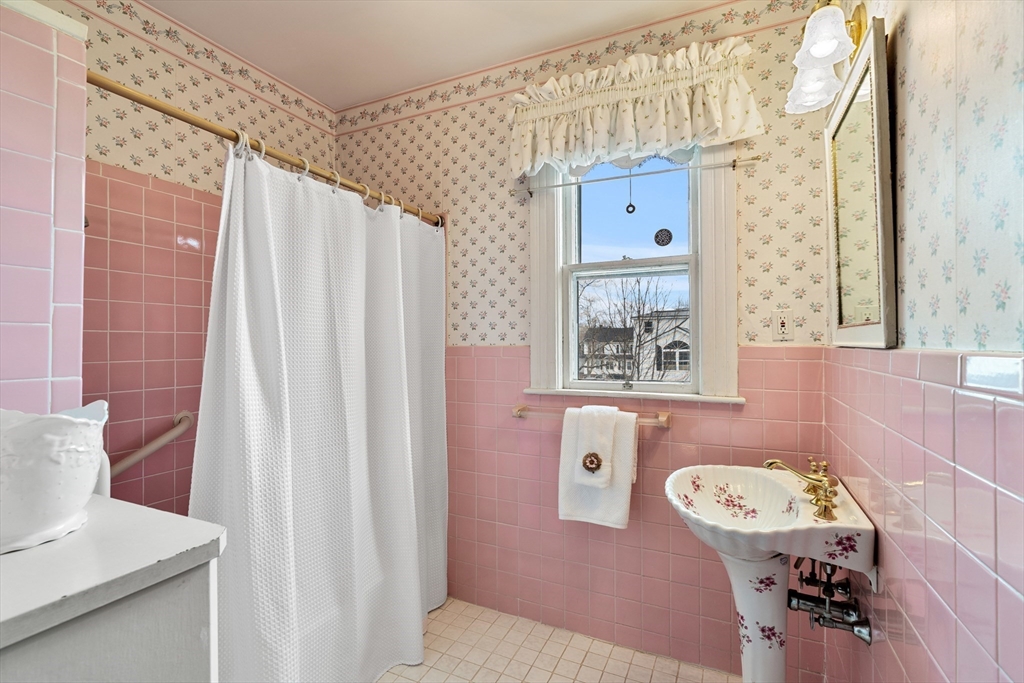 118 Sanders Avenue Lowell, MA 01851 - Photo 34 of 42 a bathroom with a bathtub sink and mirror