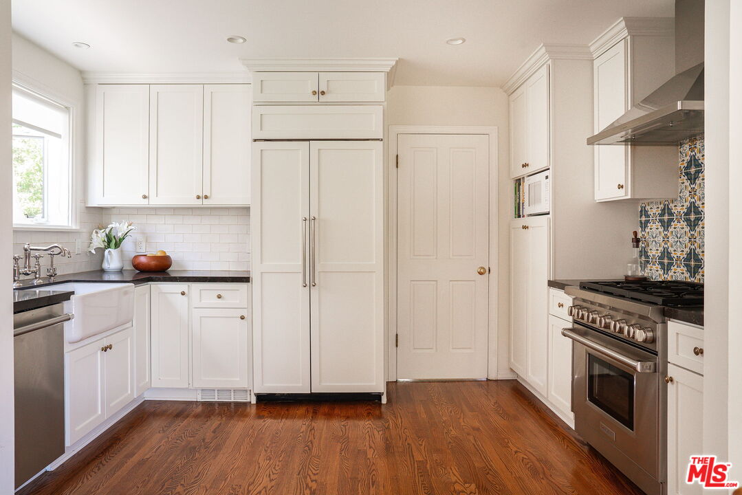 2166 Las Lunas Street Pasadena, CA 91107 - Photo 18 of 64 a kitchen with stainless steel appliances white cabinets and wooden floors