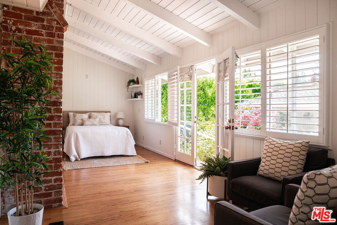 2166 Las Lunas Street Pasadena, CA 91107 - Photo 25 of 64 a spacious bedroom with a bed and a couch next to a window