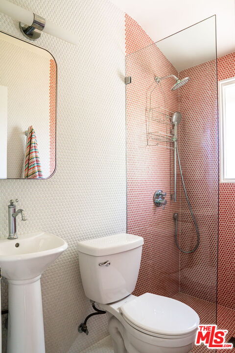 2166 Las Lunas Street Pasadena, CA 91107 - Photo 29 of 64 a white toilet sitting next to a bathroom sink