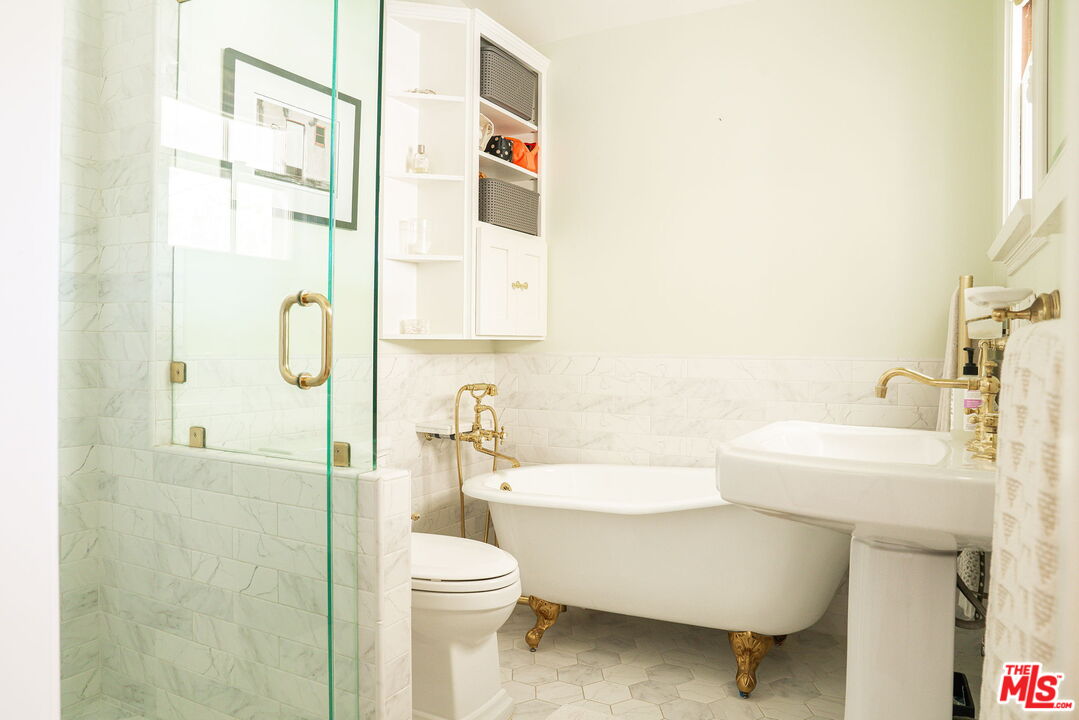 2166 Las Lunas Street Pasadena, CA 91107 - Photo 35 of 64 a bathroom with a white toilet sitting next to a bathroom sink