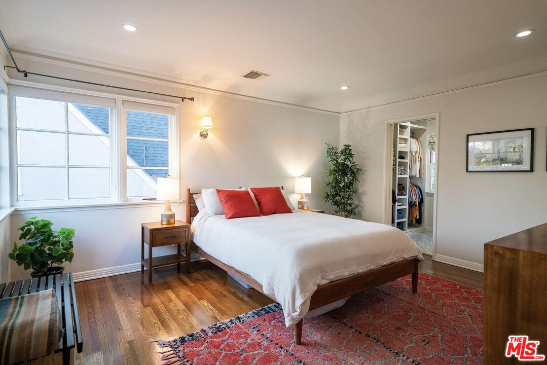 2166 Las Lunas Street Pasadena, CA 91107 - Photo 38 of 64 a bedroom with a large bed and a potted plant