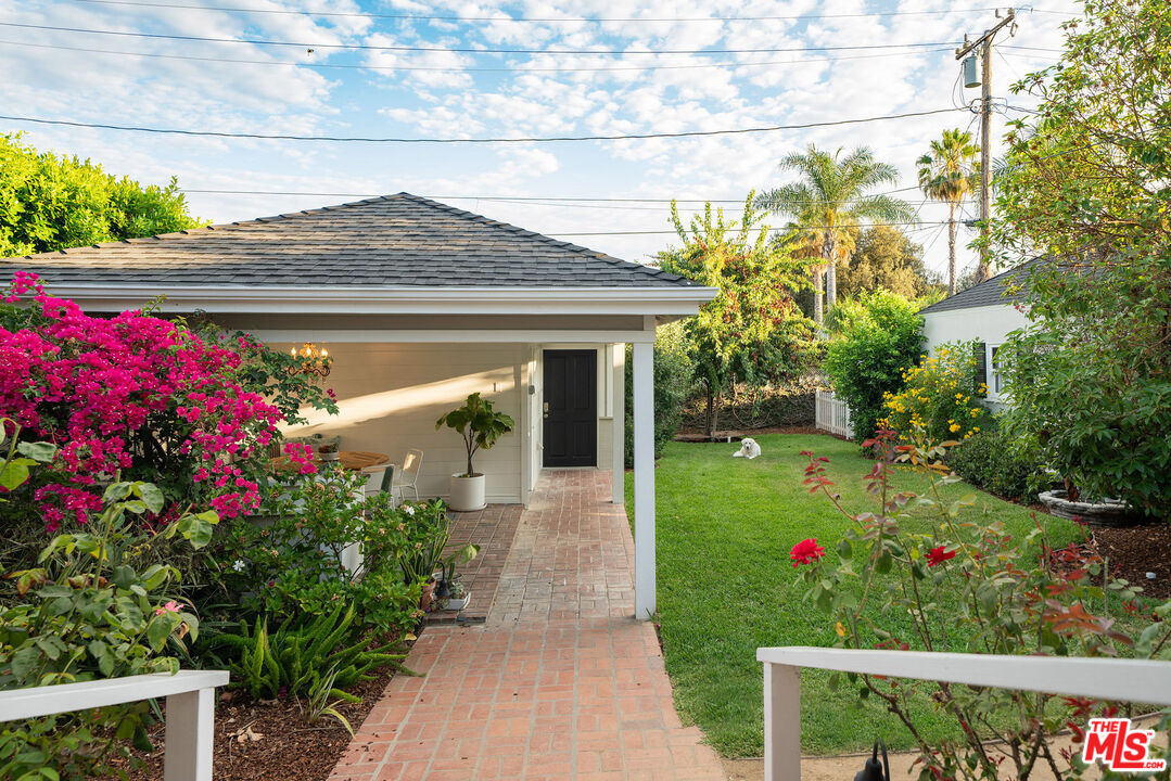 2166 Las Lunas Street Pasadena, CA 91107 - Photo 41 of 64 a front view of a house with a yard and fountain