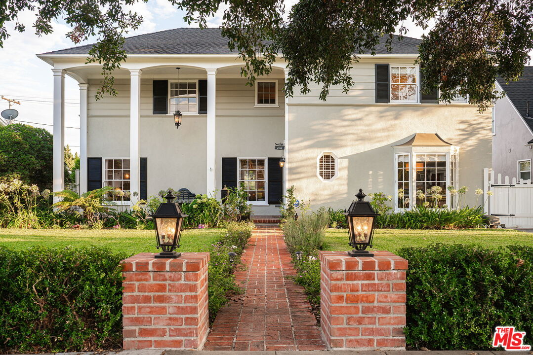 2166 Las Lunas Street Pasadena, CA 91107 - Photo 5 of 64 a front view of a house with a yard table and chairs