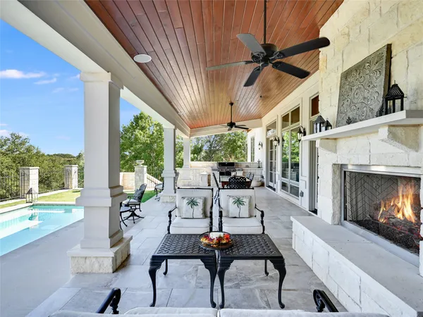 a living room with patio furniture and a fireplace