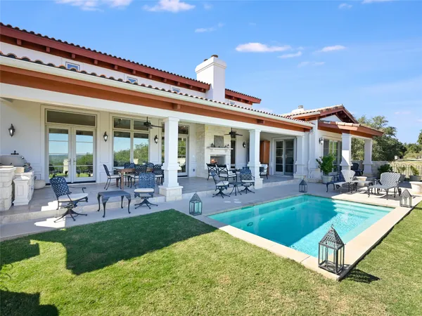 a view of a house with backyard porch and outdoor seating