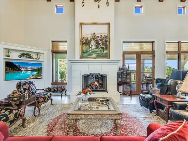a living room with furniture a rug and a fireplace